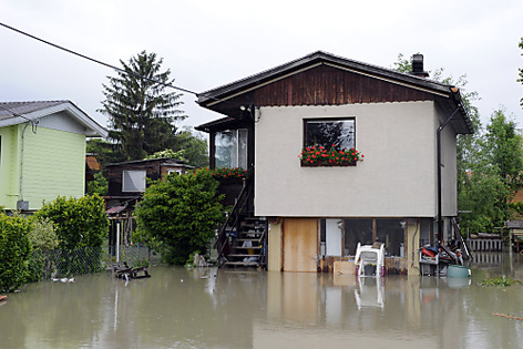 Haus steht auf Säulen, am Parkplatz schon das Hochwasser