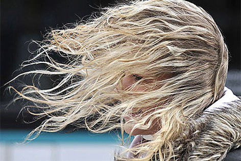 Wind bläst einer Frau durch die Haare
